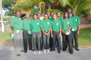  Guyana’s Junior Commonwealth team posing with coaches and chef-de-mission in front of Olympic House before their departure for India via New York. From left, Boxing coach Carl Franklyn, Table Tennis Coach Linden Johnson, Michelle John, Nigel Bryan, Trenace Lowe, Cleveland Rocke and Stefan Gouveia (partially hidden), Herlando Allicock, Chef-De-Mission Karen Pilgrim (back), Ambrose Thomas, Terrence Poole (back) and Akeem Alexander all decked out in their Guyana blazers.