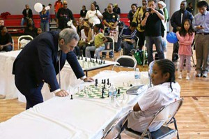 Garry Kasparov might be retired but he is still active in chess with the Kasparov Chess Foundation, a non-profit educational organization that works with schools and communities across the United States to promote chess as a cognitive learning tool. Recently he visited the Harlem Children’s Zone, an anti-poverty and education initiative. Presidential candidate Barack Obama visited the Zone and praised the programme in a speech last year. In picture, Kasparov gives Rochelle Ballantyne one-on-one attention as Rochelle’s colleagues had all resigned. Naturally Rochelle would have preferred not to have this kind of attention during the simultaneous exhibition.    