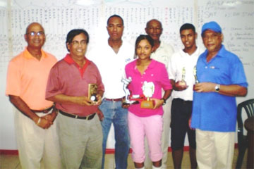 Joann Deo (fourth right) with Ansa McAl representative Nigel Worrell (third right) and other prize winners and officials of the Lusignan Golf Club.   