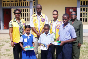 North Georgetown Primary students (in front row) Melinda David, Calvin Robinson and Levi McKenzie display books and other items donated to them by the Lions Club of Georgetown. Also pictured (in back row) are Club President Jason Gray, Lions Lynette Baird and Grace Sylvain and Principal Yvette Williams.  