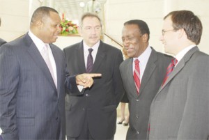 Barbados’ Minister of Foreign Affairs and Foreign Trade, Chris Sinckler (left) is all smiles as he discusses yesterday’s EPA signing with Jean Paul Dumont (second from left), the Ambassador of France to Caricom, Edwin Carrington, Secretary General of Cariforum, and Gareth Thomas (right), the United Kingdom’s Under-Secretary of State for International Development, at the Sherbourne Conference Centre. (Barbados Nation photo)  