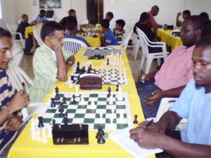 Chess players battle their opponents at the Hotel Tower for a chance to play in the National Chess Championships of Guyana. A maximum of seven players would go forward in the senior division and eight from among the juniors. National Champion Kriskal Persaud has qualified automatically as the current National Champion. Last year’s Junior Chess Champion Ronald Roberts cannot advance in the junior category since he is now over the stipulated age of 18 years, and is therefore considered an adult. Roberts is playing among the seniors this year. On the second chess board, Shiv Nandalall ponders his next move as Ronuel Greenidge studies the board. Both players are favourites to go forward. 