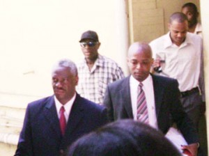 Magistrate Gordon Gilhuys (left)leaving Court One yesterday after he was granted self-bail in the Georgetown Magistrate’s Court.