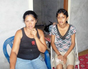 Basmattie Rampersaud (left) and Shivanie at their home yesterday. 