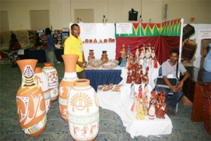 Prize winner Trevor Alfred (left) and Mohamed Kahmar (another local participant) in their booths at the Caribbean Gift & Craft Show in Barbados. (Jack Farley photo) 