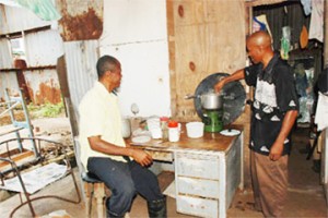 Glen Grant (left) and Keith Grant cooking in their makeshift home. 