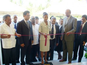 Chancellor of the Judiciary (Ag.), Carl Singh, second from right and regional chairman, Harrinarine Baldeo, at left, assisting to cut the ribbon to declare the building open as Magistrate Tejnarine Ramroop, second from left, and Principal Magistrate Krishndat Persaud (third from right)look on.