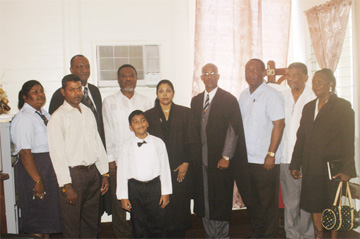Chandrawattie Persaud (fifth from right) with family members and others who attended the bar admission ceremony. Prime Minister Sam Hinds is sixth from right and the President of the Guyana Public Service Union, Patrick Yarde is third from right. 