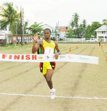 NUMBER ONE! Guyana’s Cleveland Forde crosses the finish line unchallenged at the Police Sports Club ground, yesterday in the sixth annual IAAF South American 10K Road Race Classic. (Lawrence Fanfair Photo)   