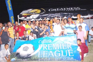 The FIRST! The Alpha United team poses with GT&T’s Marketing Manager Wystan Robertson (with trophy) and Alpha United supporters at the Tucville Playfield after winning the GT&T Cellink Plus Premier League championships for the third consecutive year on Sunday.  