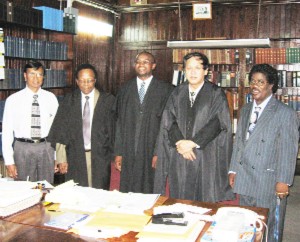 Dylon Bess (centre) poses with, (from left to right), Andrew Bishop, Commissioner of the Guyana Lands and Surveys Commission, attorney-at-law Gerald Brooms, Chief Justice Ian Chang and Leon Rutherford.   