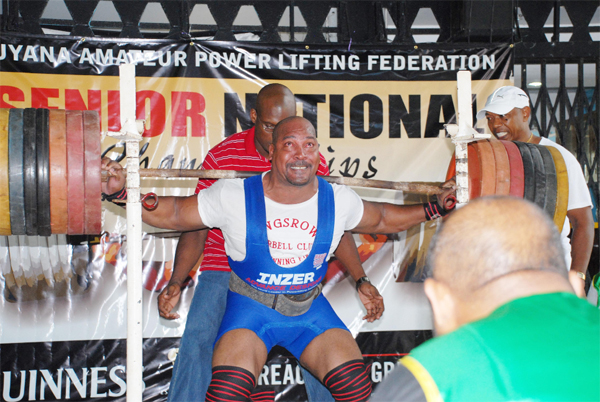 In this Clairmonte Marcus photo, John ‘Big John’ Edwards has almost completed his record breaking squat of 749¼lbs in the GAPLF’s Senior National Championships at the Banks DIH Thirst Park Sports Club. 