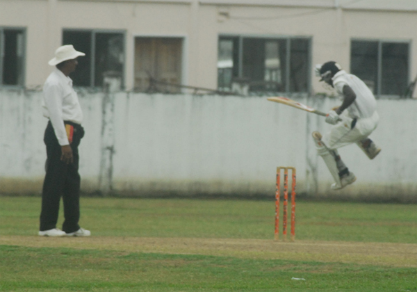 CELEBRATION!  Former national under-19 batsman Shemroy Barrington jumps in the air after recording his second consecutive century in the Guyana Cricket Board (GCB) President’s Cup competition against the Lance Gibbs Tigers yesterday. Umpire Dhieranidranauth Somwaru looks on at left (Lawrence Fanfair photograph) 