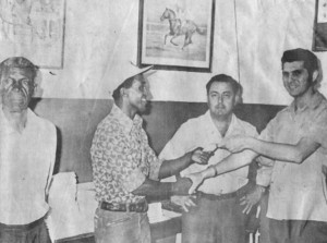 FLASHBACK! Harold Mack stands at left as Lennox Beckles receives a cheque for $100 from Federal Racing Service manager Attie Joseph, at the racing service. The cash represented an incentive prize offered by boxing fans and enthusiasts for the welterweight clash between Beckles and Vernon Lewis where Beckles earned a unanimous decision. At centre is Beckles’s manager Mike Correia.   