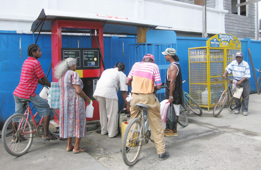  Consumers purchasing kerosene oil at a gas station in New Amsterdam yesterday morning. 