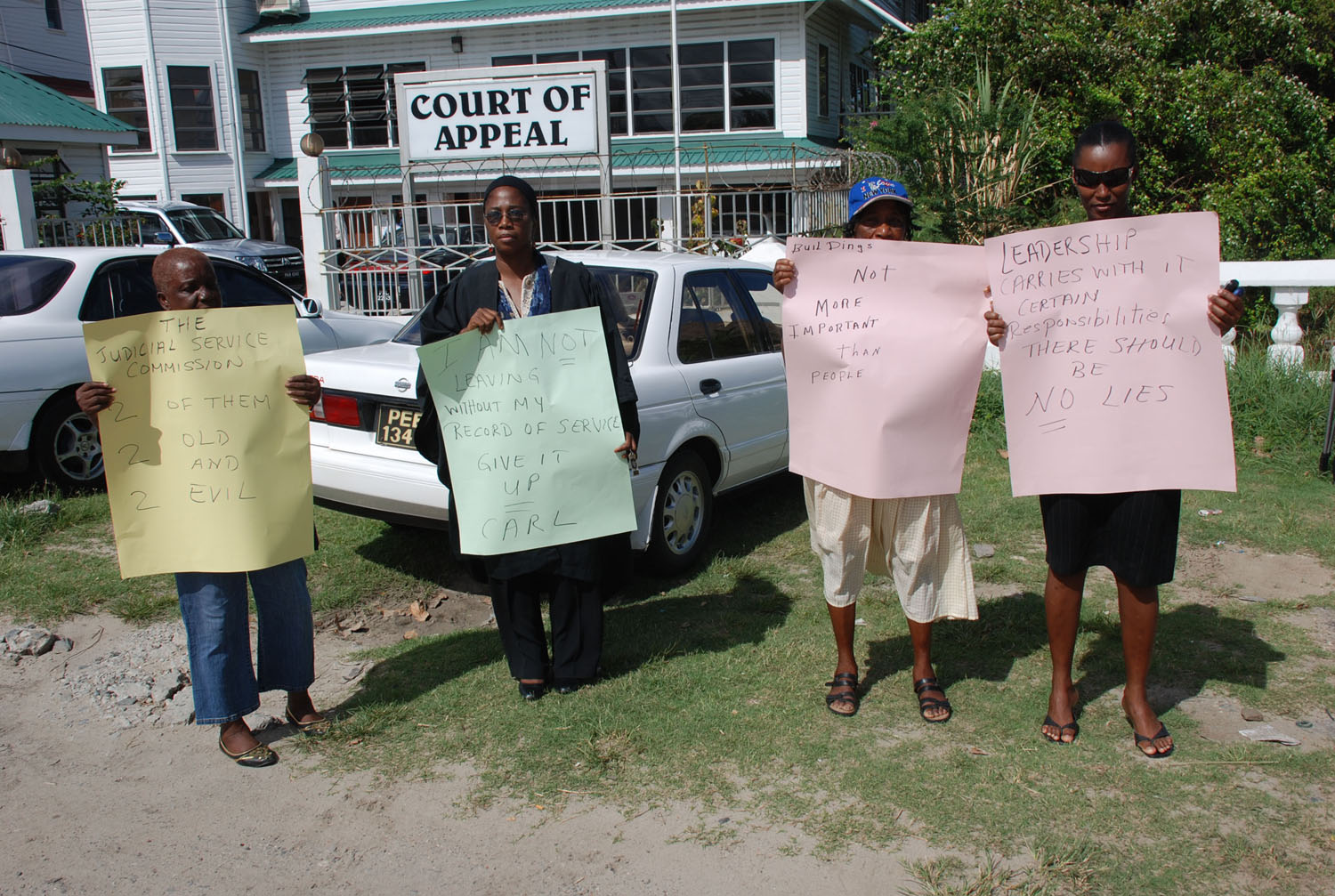 Former Chief Magistrate Juliet Holder-Allen and a few of her supporters staged a protest action in front of the Court of Appeal over the delay of the issuing of her benefits for the 18 years she served on the bench. Holder-Allen resigned from the bench on September 2 last after being sent on indefinite leave almost five years ago following allegations of misconduct. At that time, the former magistrate had said she and her former employers would have to discuss her benefits but so far there has been no discussions hence her protest action. Yesterday the former magistrate said she knows the Judicial Service Commission had no intention of preparing her record of service so that she could receive her retirement benefits. Holder-Allen said she drew that conclusion because of the terse note the commission rote her in response to her letter of withdrawal of service and the note was to effect that “from the 15th September 2008 you will no longer be a magistrate. Goodbye. There was no mention to me of the state or payment to me of my monetary benefits. There were no words of thanks for my services or regrets that it has ended or any such thing,” the former magistrate said. The placard she held by during yesterday’s protest read, “I Am Not Leaving Without my Record of Service Give It Up Carl [in reference to acting Chancellor Carl Singh].” 