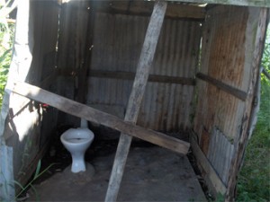 The abandoned outhouse located in a yard on Norton Street, where the injured gunman was found yesterday. 