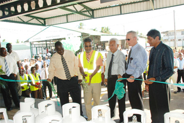 Minister of Labour Manzoor Nadir (fourth from right) is flanked by  Chevron representative Raymond Samuel (fifth from right), and CEO of  Neal and Massy (Guyana) Deo Persaud, Christian Maingot (second from right) and  DOCOL CEO Shameer Hoosein after the symbolic cutting of the ribbon. 