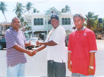 Above, Ramcharitar, left, is seen handing over the sponsorship cheque to Roberts while club captain of the Flying Ace Cycle Club, Neil Reece looks on.