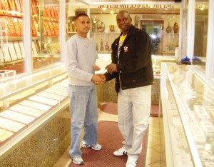 Managing Director of Robin’s Jewel Shop, Robin Persaud (L) hands over a sponsorship cheque to Director of the Kashif & Shanghai Organization  Aubrey Major (R) in Robin’s Jewel Shop, Brooklyn, NY recently.