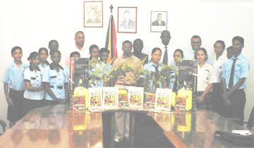 Students of School of the Nations, Marian Academy and the Institute of Business Studies and their school representatives with the seeds, plants, farmers’ manuals and other items that were given to them by the Ministry of Agriculture yesterday. This is part of the ministry’s drive to promote practical agriculture in schools. Also in the photo are Minister Robert Persaud (fourth from right) and Nizam Hassan, head of the New GMC. 