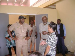 Commander Fernandez Ponds (left) and US Ambassador to Guyana John Jones speak with Assistant Regional Executive Officer of Region One, Cassandra Rodrigues at the Kumaka District Hospital yesterday. The US officials were on a visit to the site, where the US medical mission, ‘Continuing Promise’ is ongoing.