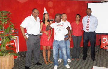 Singer Jumo entertaining the crowd, while the Digicel Fairy and Digicel executives look on. 