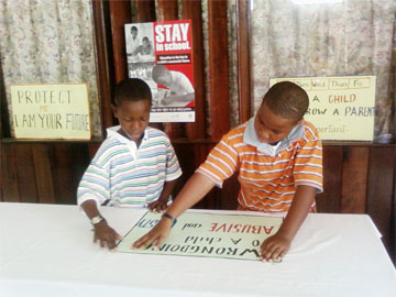 Future leaders? These two young men were putting up posters during the two-day National Children’s Conference at the Ocean View Conference Centre which opened on Friday.