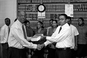 In photo Senior Counsel Ralph Ramkarran (left) makes the presentation to Manoj Narayan