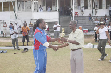 THANK YOU! Carl Wright receives his man of the Match trophy from Guyana Cricket Board vice president Malcolm Peters.(Aubrey Crawford photo)  