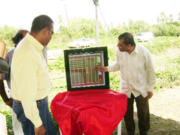 Agriculture Minister Robert Persaud (left) and Geddes Grant CEO Seu Sarran Prasad (right) examining the artist’s impression of the modern demonstration farm and training facility, after it was unveiled yesterday. 