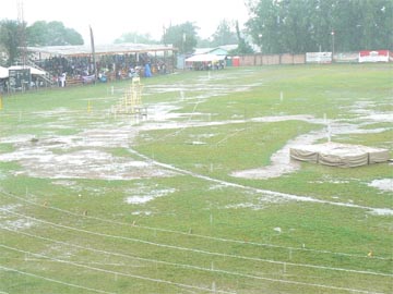 The sodden Mackenzie Sports Club ground during the large shower of rain that delayed the commencement of Day Two. To the top-left of the picture is the athletes’ pavilion with the participants from various districts grounded by the rainfall. (Kizan Brumell Photo) 