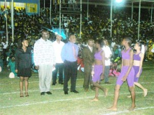 TAKING THE SALUTE! From left, PNC/R parliamentarian Vanessa Kissoon, Regional Chairman of Region 10, Mortimer Mingo, Prime Minister Samuel Hinds, and Guyana Teachers Union (GTU) president, Colwyn King, taking the salute of the athletes at the opening of the 48th annual National Schools, Track and Field, Athletics, Cycling and Swimming Championships at the Mackenzie Sports Club ground on Tuesday night. (Kizan Brumell photo)  