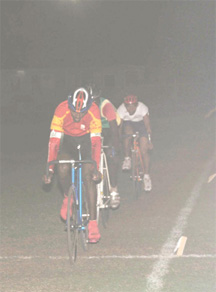 Albert Philander, forefront,  sprints to victory in the feature event on Friday night at the Everest Cricket Club ground. (Clairmonte Marcus photo) 