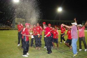 Champagne for the champs! The Trinidad and Tobago team celebrate their victory over Barbados. (Lawrence Fanfair photos) 