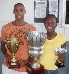 Lionel D’ Andrade, left with his third place trophy and Alika Morgan with her first place trophies won at last weekend’s marathon event in Suriname. 