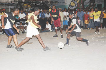 Some of the action on Wednesday evening at the Albouystown Basketball Court in the Guinness `Greatest of de Street’ football tournament. (Clairmonte Marcus photo)
