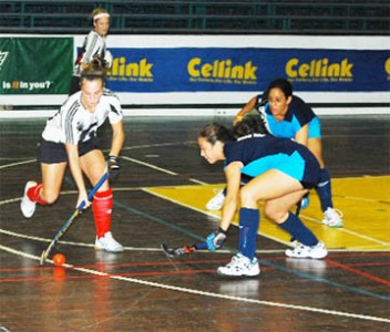 Anna Easty of GOA (with ball) evades Farzana Fiedtkou (right) and Tiffany Solomon (in background) of GCC on her way to goal as the Canadians  defeated the defending women’s champions GCC on the opening night. (Lawrence Fanfair photo)