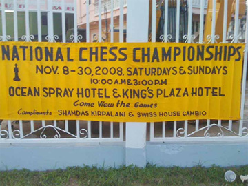 The Guyana Chess Federation displayed three banners advertising the National Chess Championships outside the National Library, and on the roadways leading to Georgetown from the East Coast and East Bank of Demerara, compliments of Shamdas Kirpalani and Swiss House Cambio. In picture is the banner on the East Bank of Demerara.