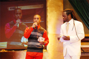 Thanking the fans: Adrian Dutchin (left) accepts one of his six awards and praises the fans for their support at the Accolade Music Awards. Also in the picture, is Chief Executive Officer of Muzik Media, Dexter Pembroke, who presented the award. (Obrey James photo) (See story centre pages) 