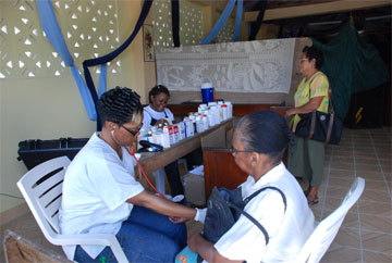 The Campbellville Christian Mission Church hosted a medical outreach at the church located at 52 Campbellville Housing Scheme yesterday. In photo, a resident has her blood pressure checked while another approaches the pharmacist.   