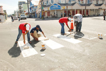 The National Road Safety Council repainting the crossing at Regent and Camp streets yesterday. 