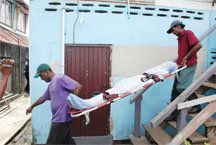 Undertakers from Lyken’s removing the body of Fiesal Ali from his Lot 179 Mandela Avenue home yesterday morning.  