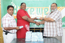 CEO of Bakewell Naeem Nasir (R) presents a batch of the six thousand tickets to Assistant Chief Education Officer of the Ministry of Education Melcita Bovell (centre) while General Manager of Bakewell Rajin Ganga (L) looks on. (Clairmonte Marcus Photo)    