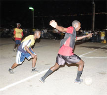 In this Clairmonte Marcus photo, Albouystown’s Andrew Murray Jnr. (with ball) is seen going on the attack against Broad Street ‘A’ in the final day of the preliminaries of the Guinness Greatest of De Street Football tournament. 