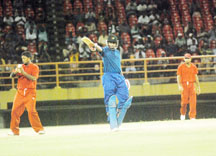 Flashback: Demerara’s all-rounder Christopher Barnwell (centre) acknowledges the applause of his teammates and the crowd, after reaching the half-century mark against Berbice in the GCB/El Dorado final while Narsingh Deonarine (with ball) and Assad Fudadin look on. (A Lawrence Fanfair photograph) 