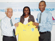 Neal and Massy CEO Deo Persaud (left) hands over one of the uniforms to assistant secretary/treasurer of the GFRC Dion Inniss while Shivaughn Wilson (centre) looks on. 