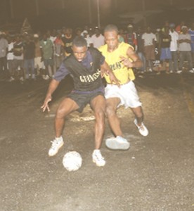 In this Clairmonte Marcus photo, quarter-final action heats up in the Georgetown Football Association’s Guinness Greatest of De Street football competition on Tuesday evening at the National Cultural Centre tarmac. 