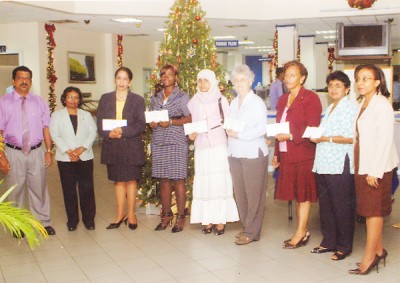 Recipients of the donations along with bank officials: Terry Gopaul (left), Vidya L Singh – Senior Manager (Operations) (second from left) and Officer-in-Charge of Human Resources and Administration, Colette Lyken (right) 