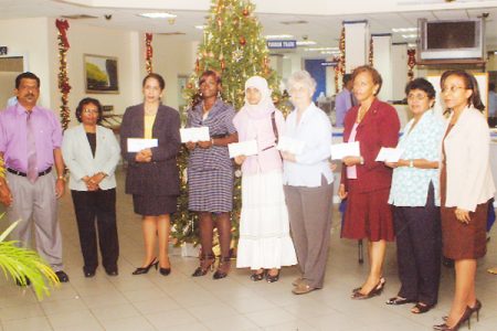 Recipients of the donations along with bank officials: Terry Gopaul (left), Vidya L Singh – Senior Manager (Operations) (second from left) and Officer-in-Charge of Human Resources and Administration, Colette Lyken (right) 